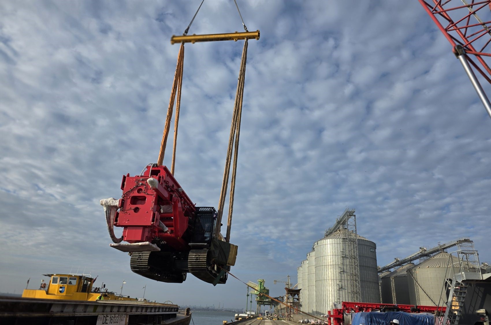 Crawler bulldozer lifted by spreader bar